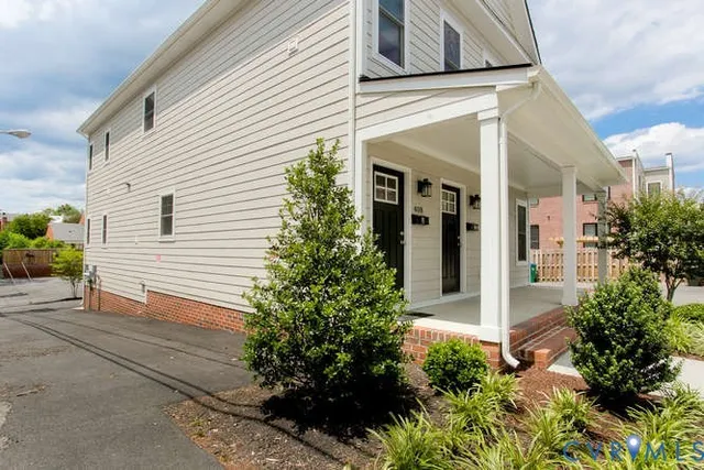 a view of a house with potted plants