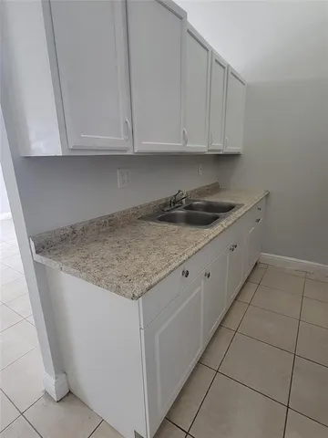 a kitchen with granite countertop cabinets and sink