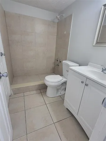 a white toilet sitting next to a bathroom sink