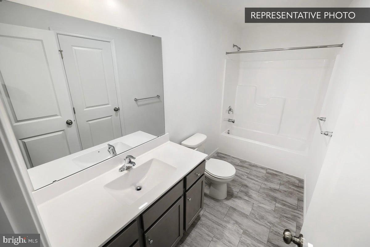 Pin Oak Plan At The Seasons Dover, PA 17315 - Photo 13 of 14 a bathroom with a sink a toilet and shower