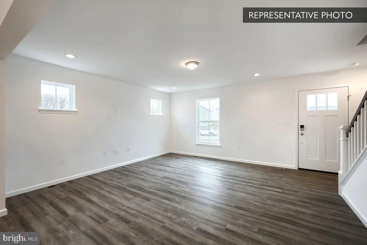 Pin Oak Plan At The Seasons Dover, PA 17315 - Photo 7 of 14 an empty room with wooden floor and windows