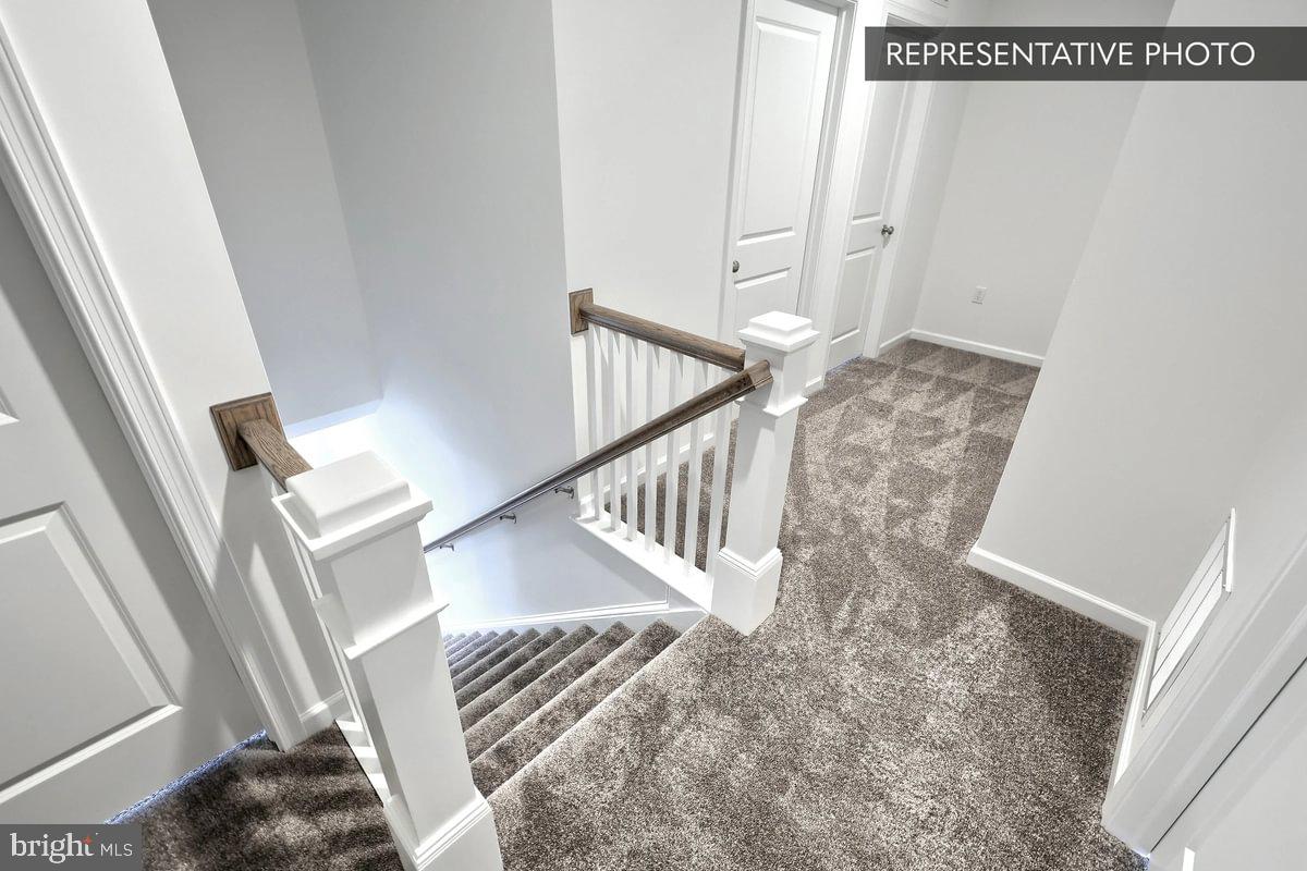 Pin Oak Plan At The Seasons Dover, PA 17315 - Photo 8 of 14 a view of staircase with lots of frames on wall and a window