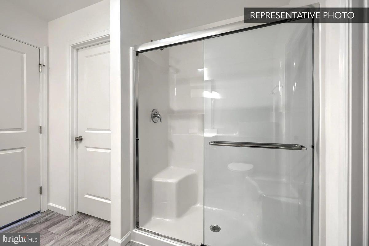 Pin Oak Plan At The Seasons Dover, PA 17315 - Photo 10 of 14 a bathroom with a glass shower door