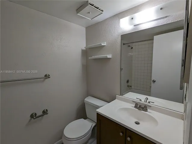 a bathroom with a sink toilet and a mirror