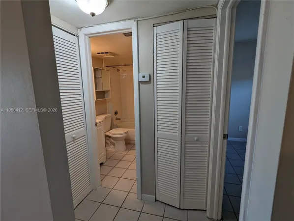 a bathroom view of a toilet and a window