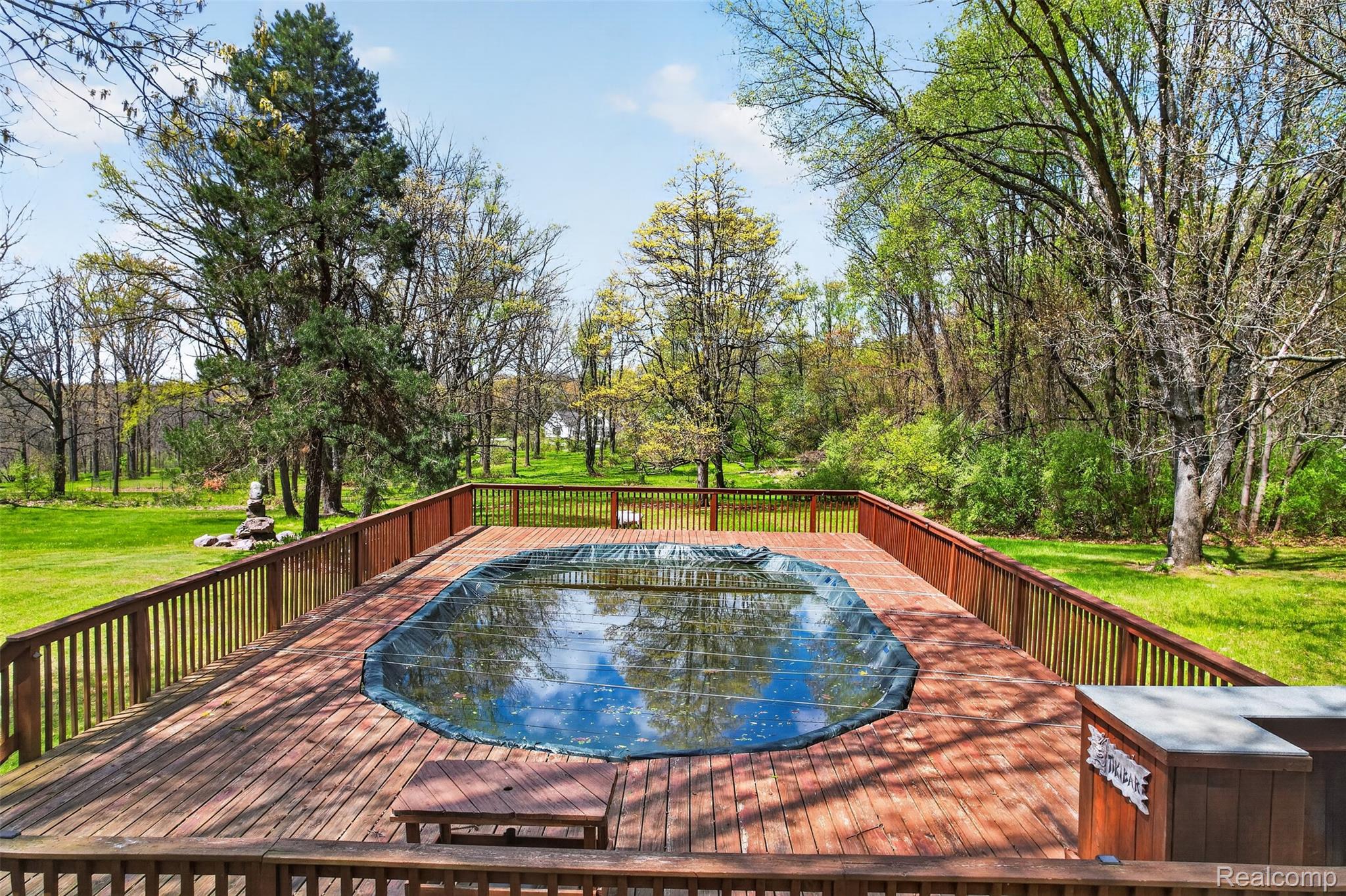 2997 Brighton Road Howell, MI 48843 - Photo 26 of 30 View of swimming pool featuring a wooden deck and a yard