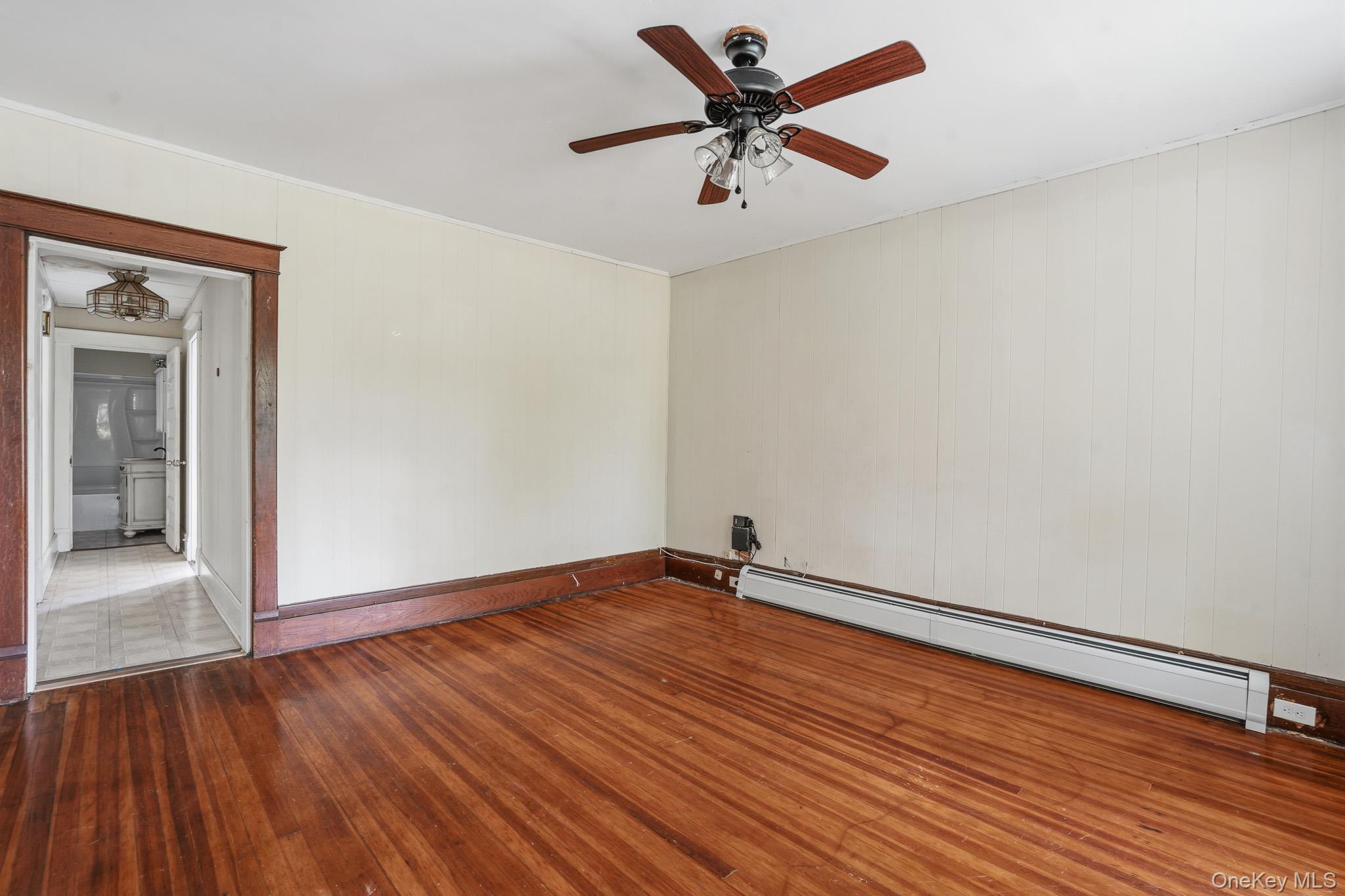 65 North Clinton Street Poughkeepsie, NY 12601 - Photo 10 of 43 an empty room with wooden floor and a ceiling fan