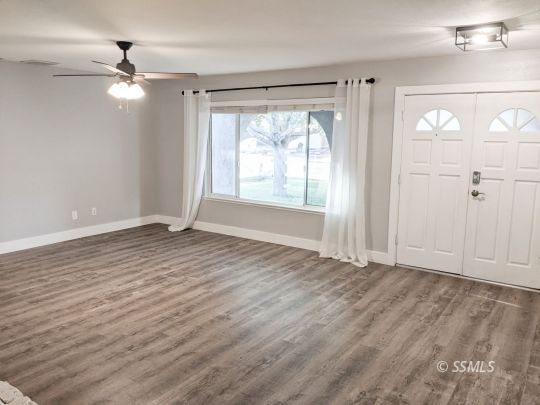 237 West Rader Avenue Ridgecrest, CA 93555 - Photo 5 of 37 wooden floor in an empty room with a window