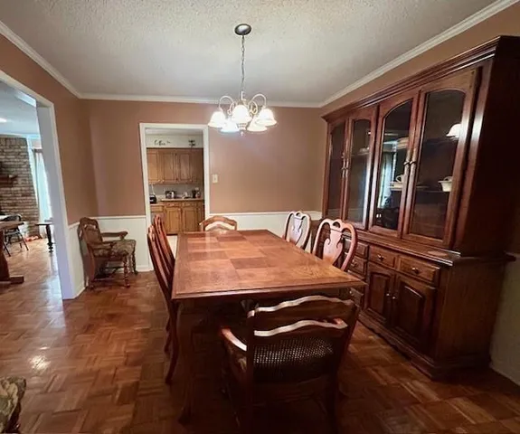 a view of a dining room with furniture and chandelier