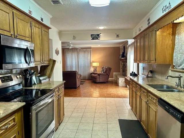 a kitchen with stainless steel appliances granite countertop a sink stove and cabinets