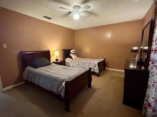 a bedroom with bed and a chandelier