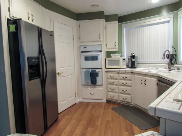 a kitchen with stainless steel appliances a refrigerator sink and cabinets
