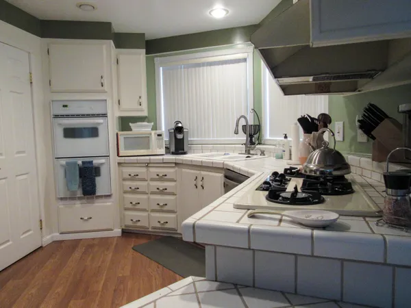 a kitchen with a stove and a refrigerator