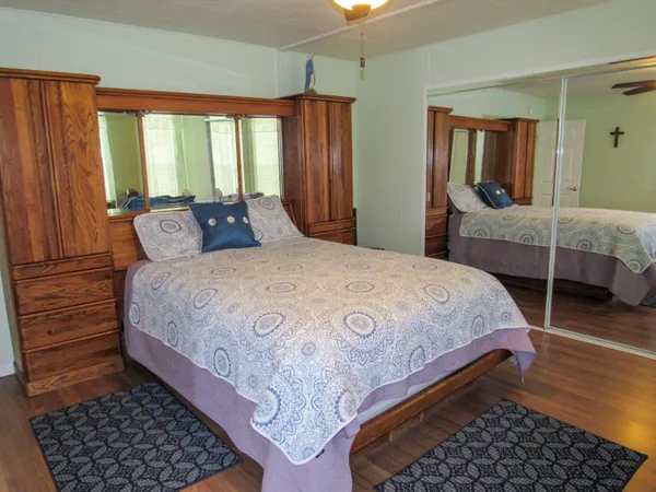 a bedroom with a bed and wooden floor