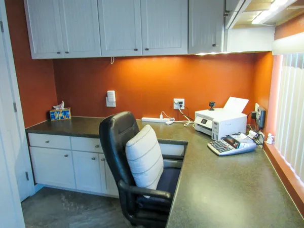 a work place with furniture and wooden floor