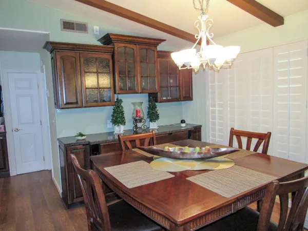 a view of a dining room with furniture and chandelier