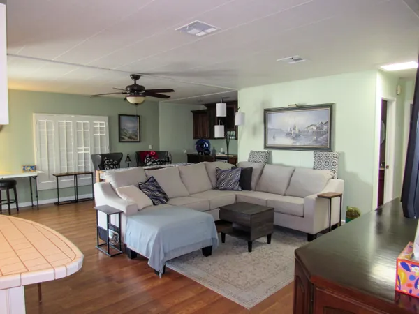 a living room with furniture and a wooden floor