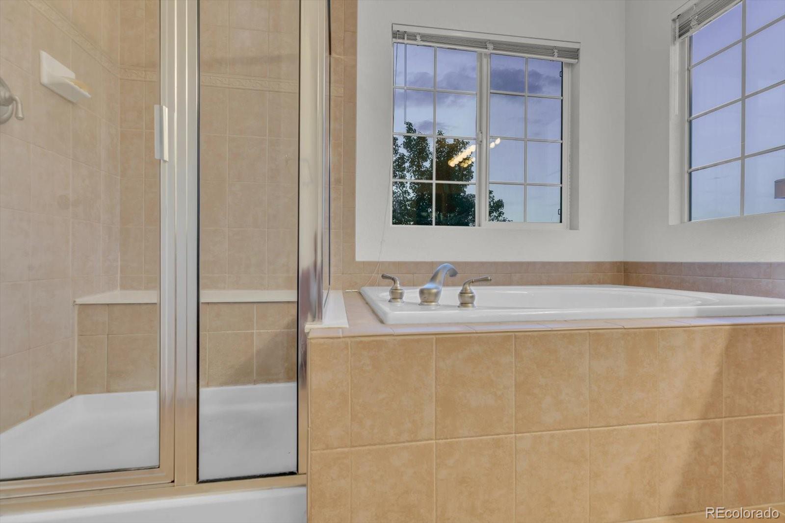 4786 Rabbit Mountain Road Broomfield, CO 80020 - Photo 20 of 41 a bathroom with a granite countertop sink and a mirror