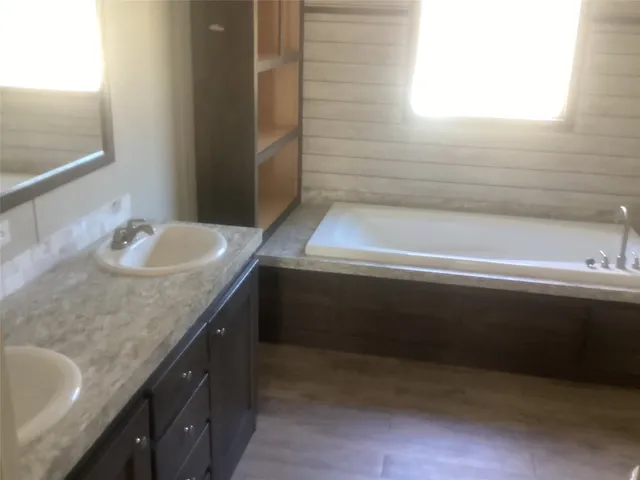 a bathroom with a granite countertop sink a toilet and bathtub