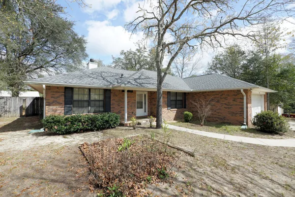a front view of a house with a yard and seating space