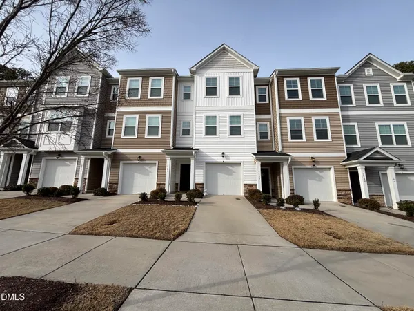 a front view of a residential apartment building with a yard