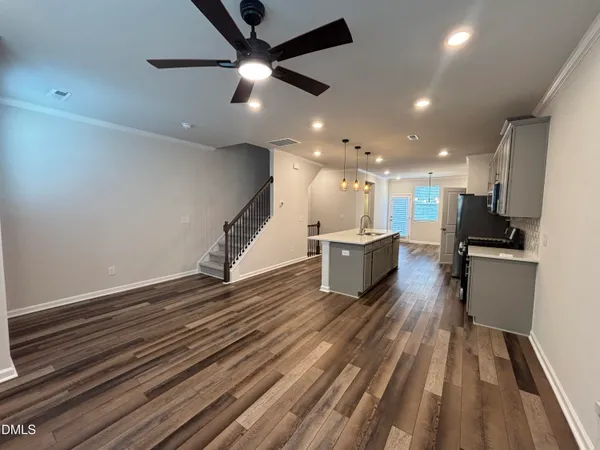 a kitchen with kitchen island a sink counter top space appliances and cabinets
