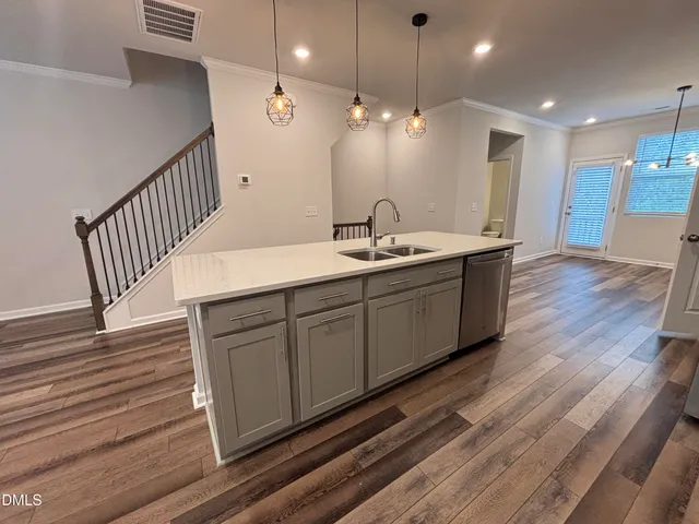 a kitchen with metallic refrigerator freezer and a sink