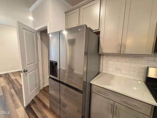 a kitchen with stainless steel appliances a refrigerator sink and stove