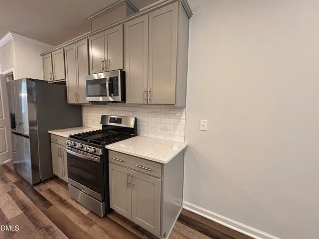 a kitchen with a stove microwave and refrigerator