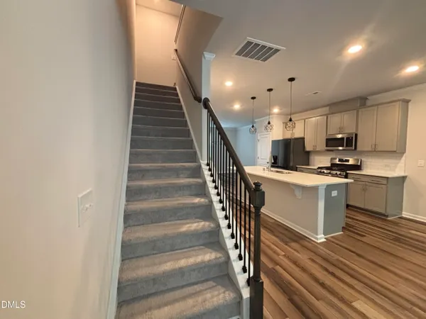 a kitchen with sink microwave and stove top oven