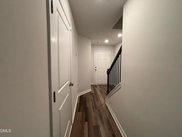 a view of a hallway with wooden floor and entryway