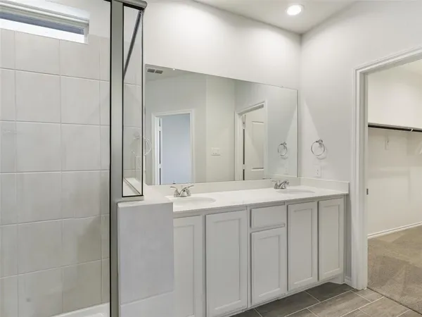 a bathroom with a double vanity sink and mirror
