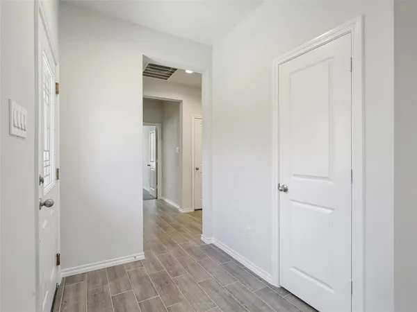 a view of a hallway with wooden floor