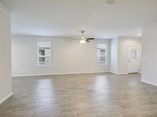 a view of an empty room with glass door