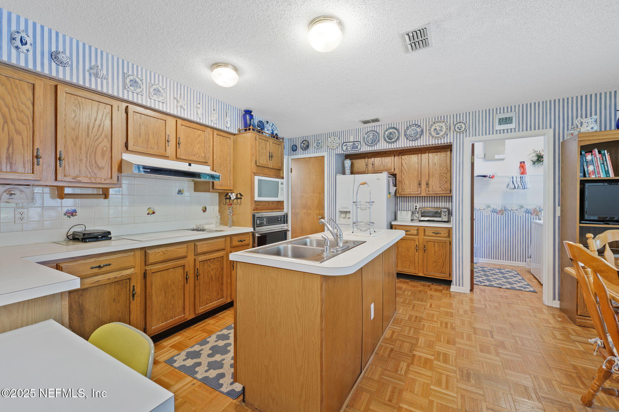 3007 Holly Road Orange Park, FL 32065 - Photo 11 of 44 a kitchen with stainless steel appliances granite countertop a sink stove and refrigerator