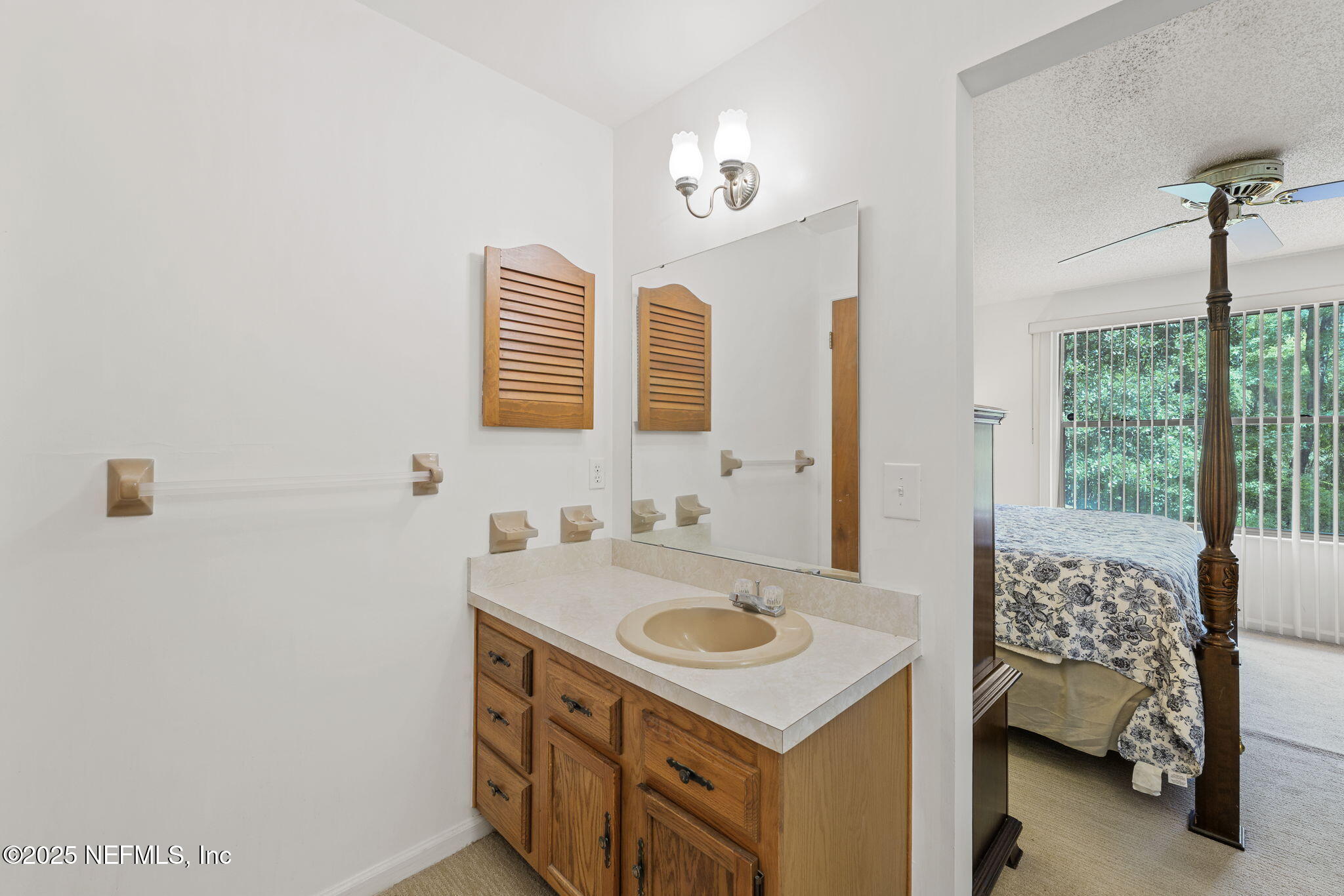 3007 Holly Road Orange Park, FL 32065 - Photo 22 of 44 a bathroom with a sink a vanity and a mirror