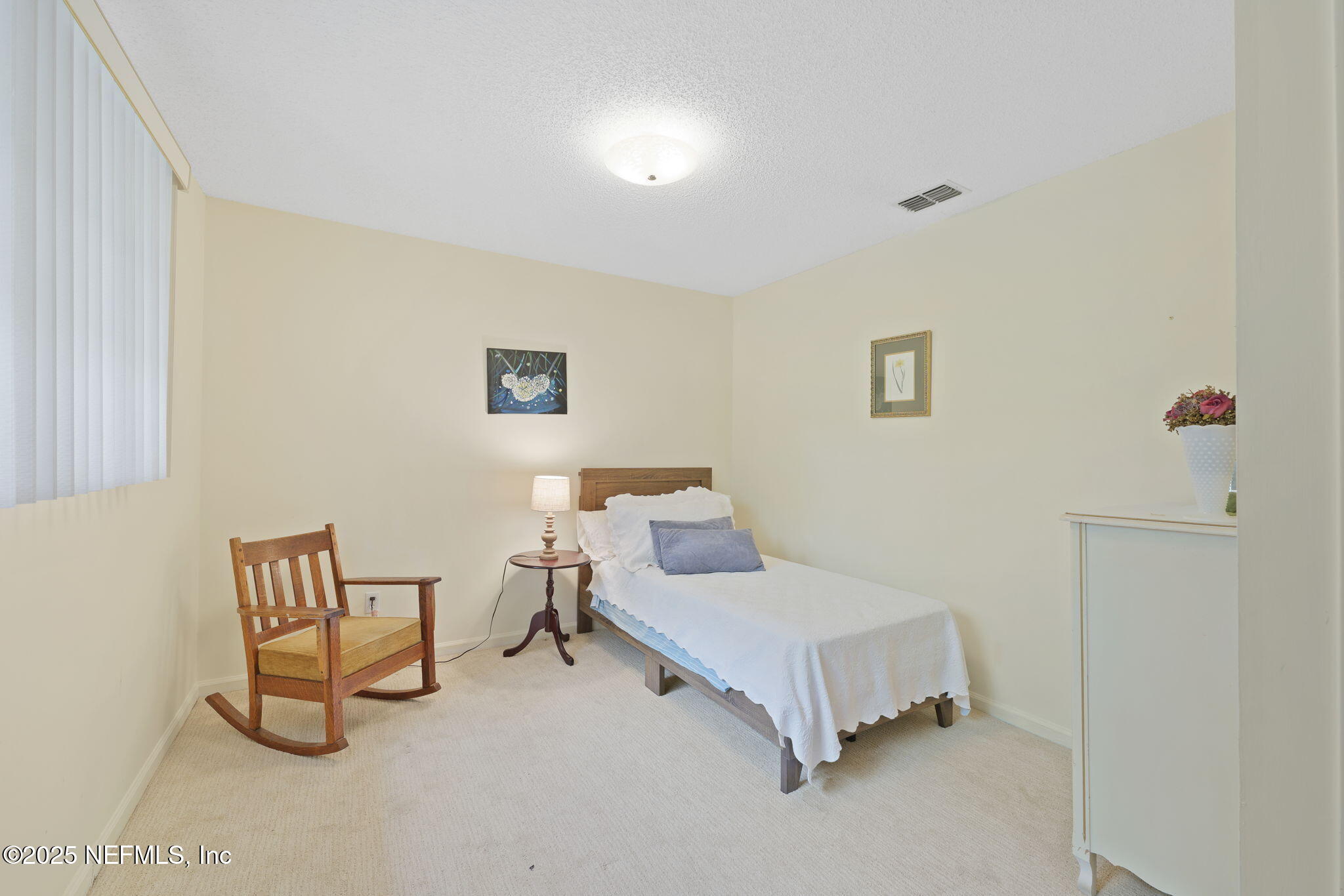 3007 Holly Road Orange Park, FL 32065 - Photo 31 of 44 a bedroom with a bed and a table in it