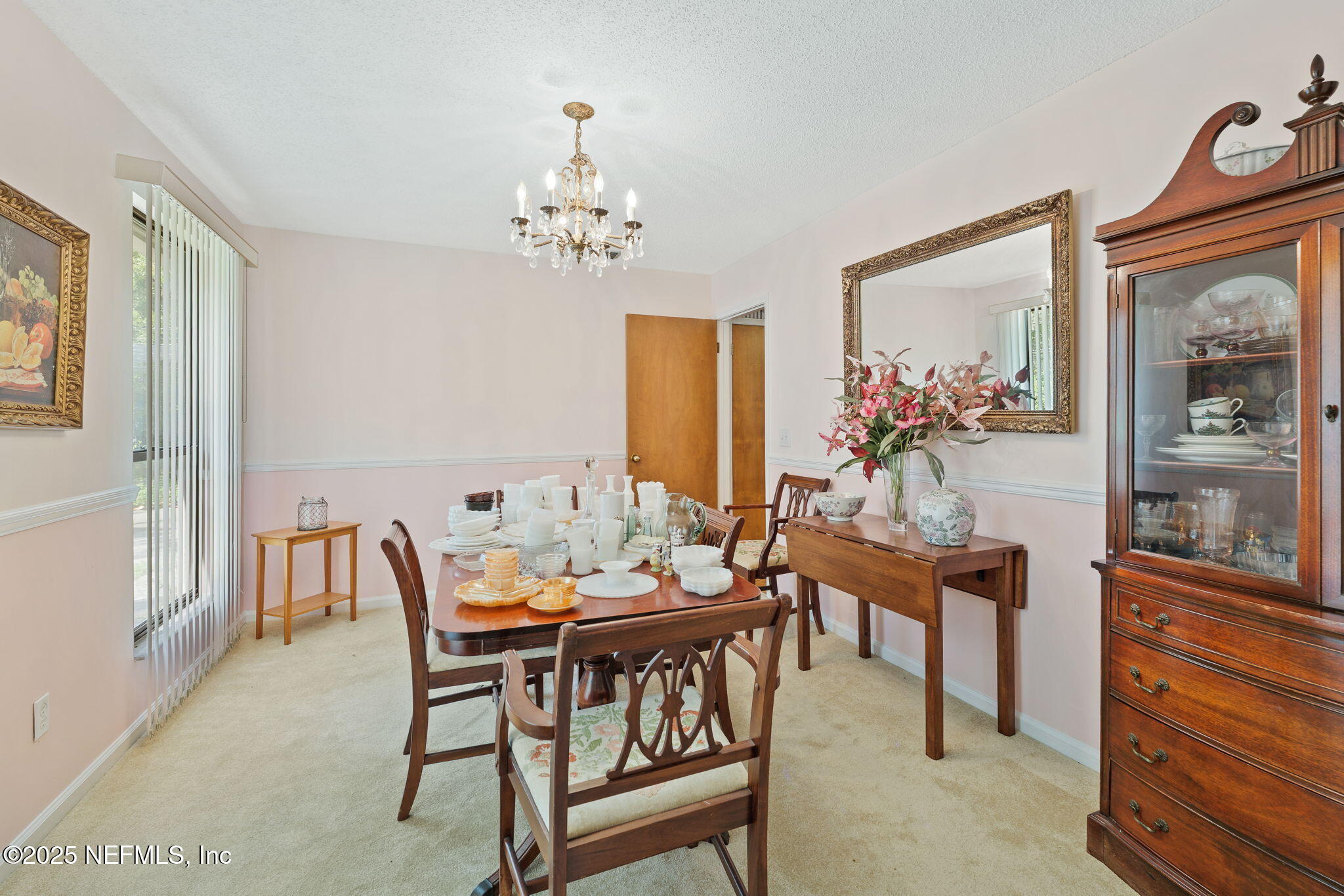 3007 Holly Road Orange Park, FL 32065 - Photo 6 of 44 a dining room with furniture a chandelier and wooden floor