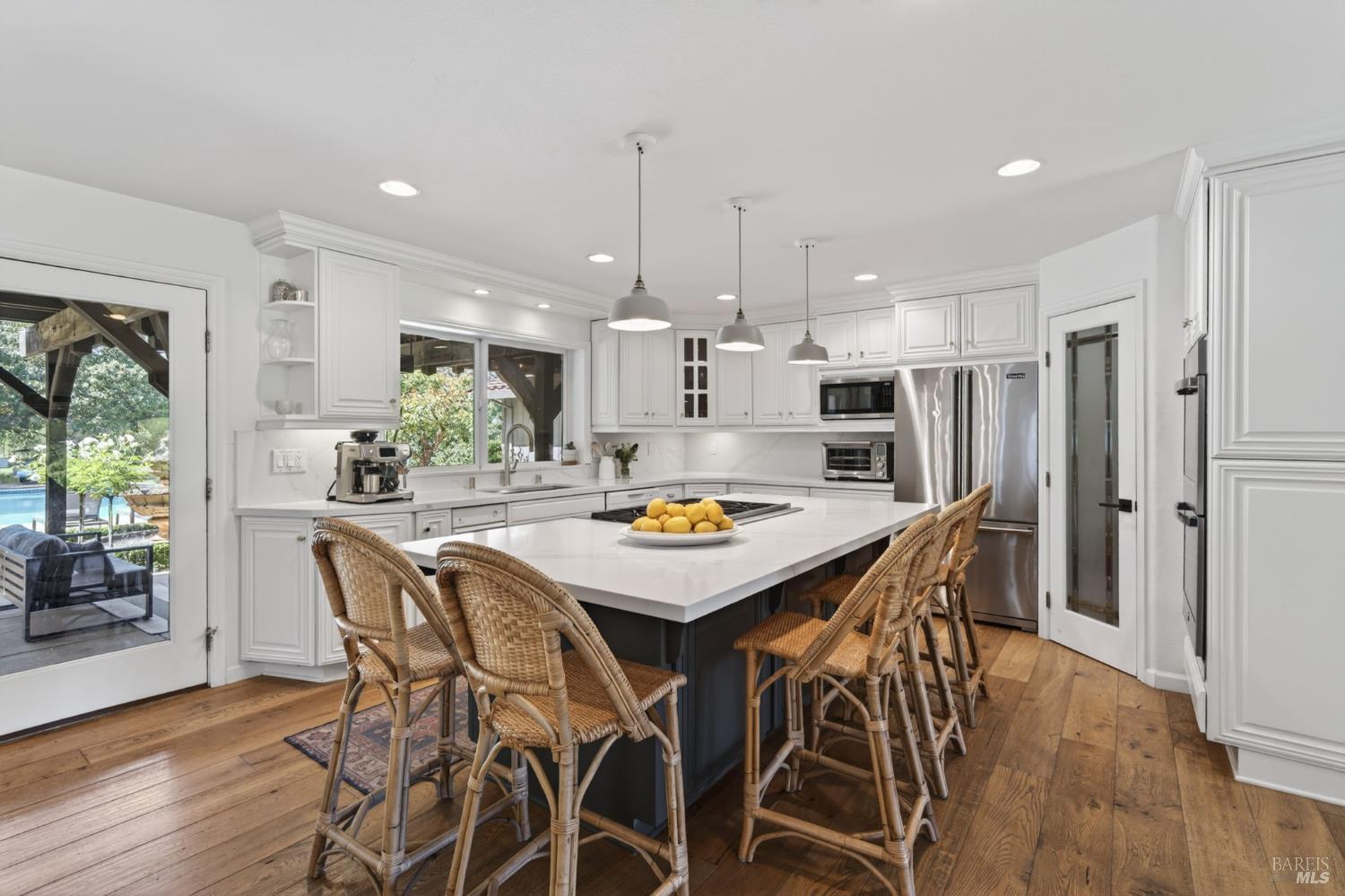 1541 Chablis Road Healdsburg, CA 95448 - Photo 12 of 68 a kitchen with stainless steel appliances a dining table chairs and wooden floor