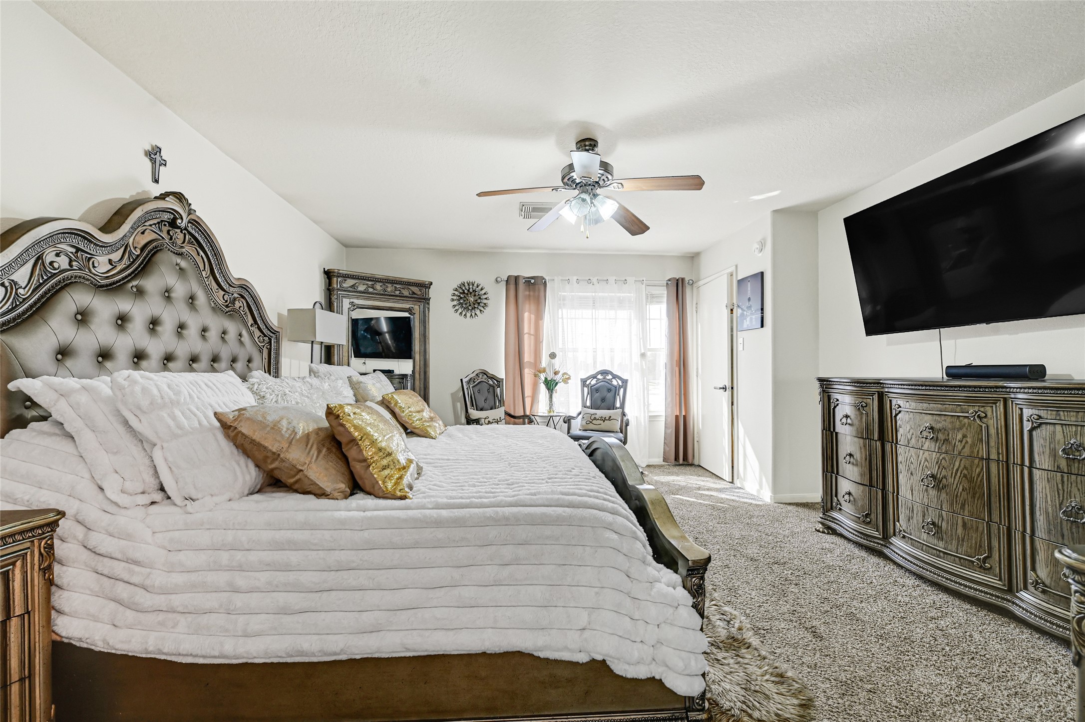 2527 Spring Lily Court Spring, TX 77373 - Photo 17 of 31 a bedroom with a bed and a flat screen tv