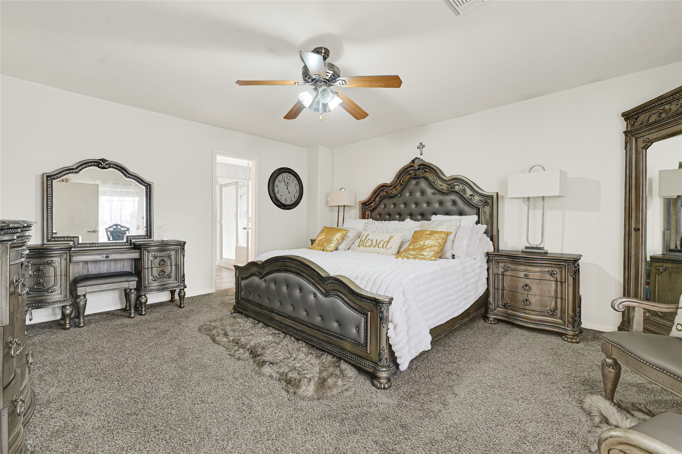 2527 Spring Lily Court Spring, TX 77373 - Photo 18 of 31 a bedroom with a bed a chandelier with a dresser