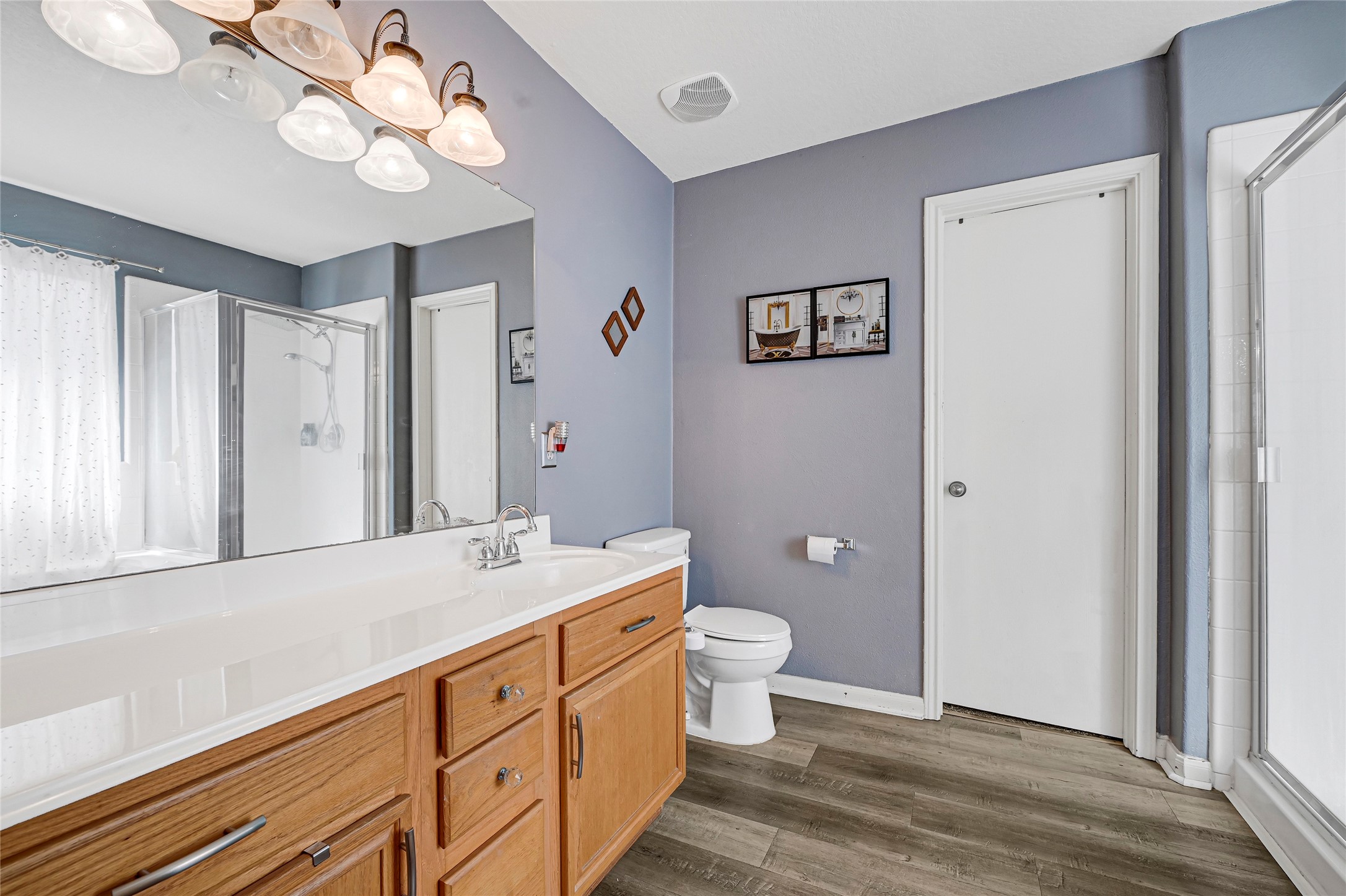 2527 Spring Lily Court Spring, TX 77373 - Photo 19 of 31 a spacious bathroom with a double vanity sink a toilet and a mirror