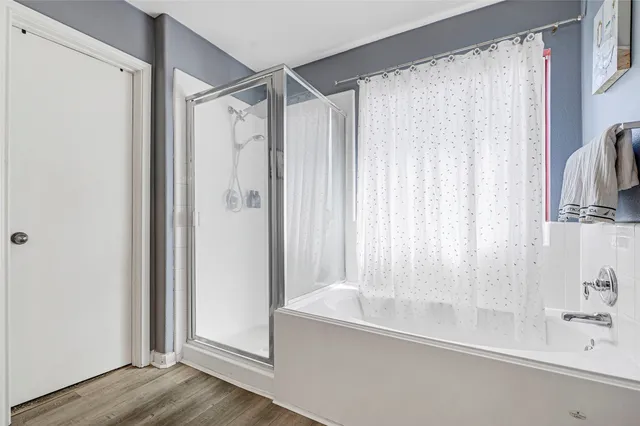 a view of a hallway with wooden floor and stairs