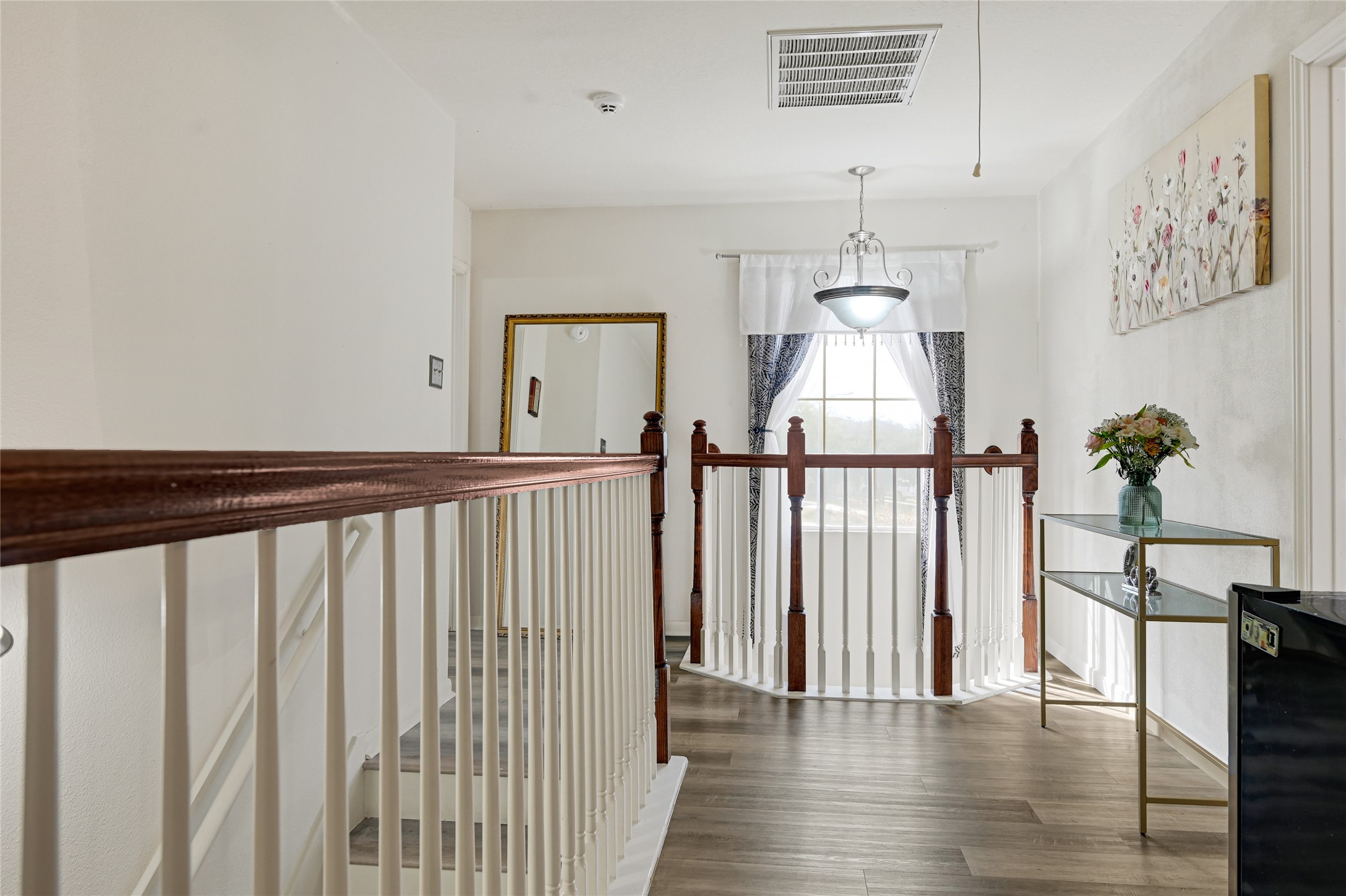 2527 Spring Lily Court Spring, TX 77373 - Photo 21 of 31 a view of a hallway with wooden floor and stairs