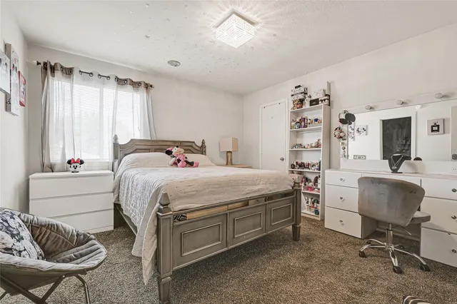 a bathroom with a granite countertop sink and a toilet