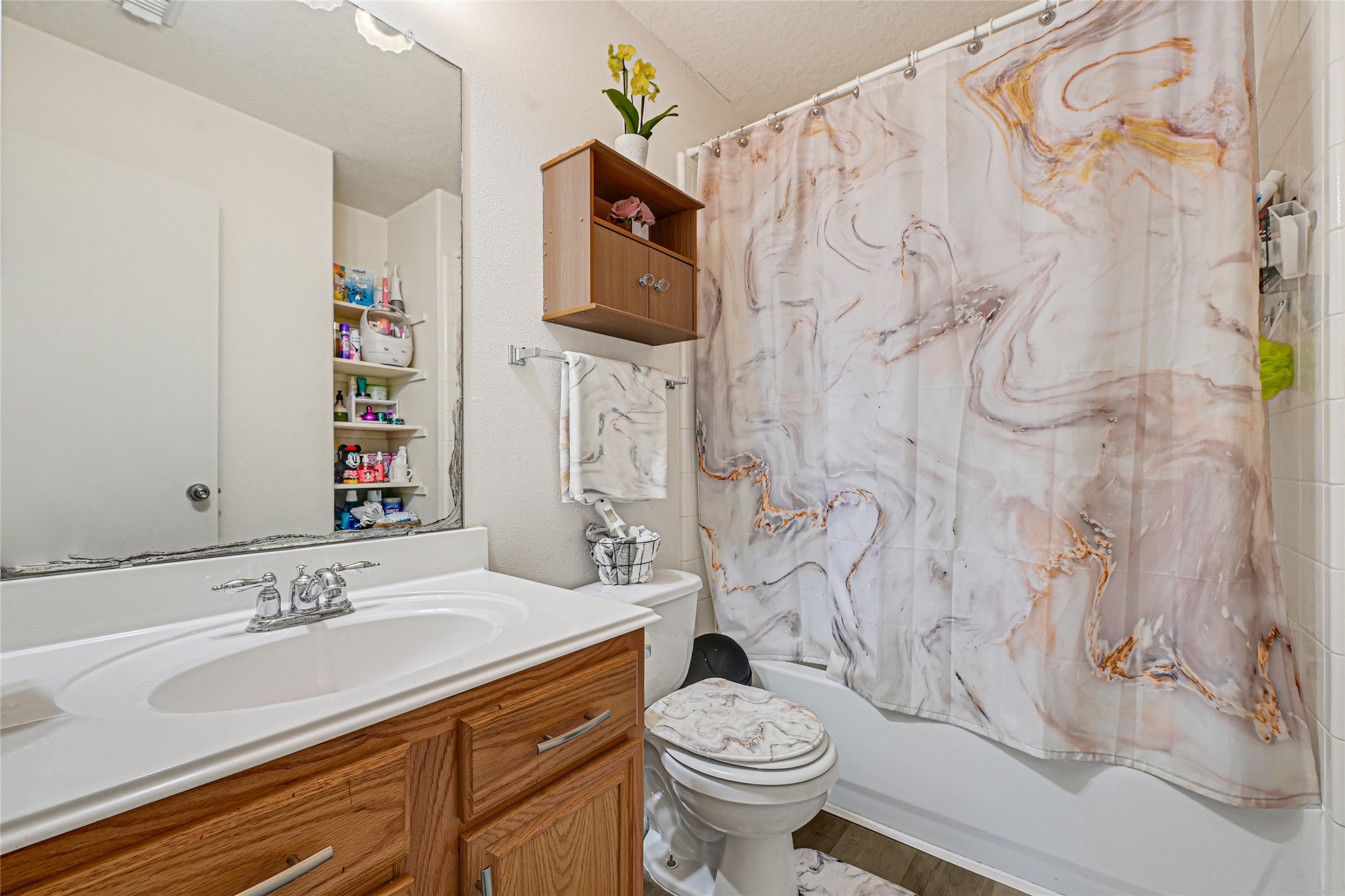 2527 Spring Lily Court Spring, TX 77373 - Photo 24 of 31 a bathroom with a granite countertop sink and a toilet