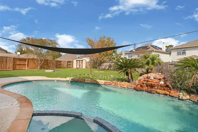 a view of a backyard with swimming pool