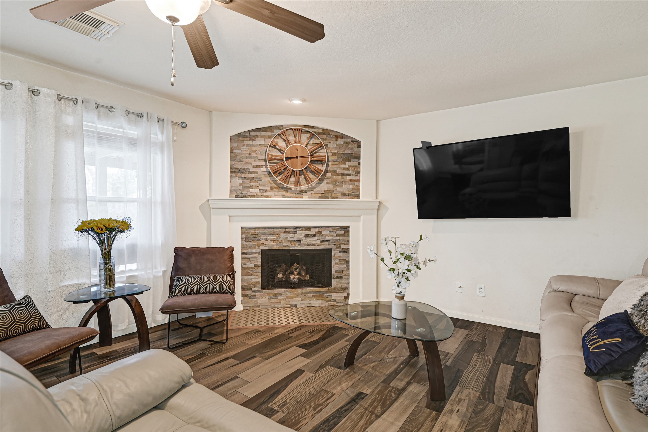 2527 Spring Lily Court Spring, TX 77373 - Photo 5 of 31 a living room with furniture a flat screen tv and a fireplace