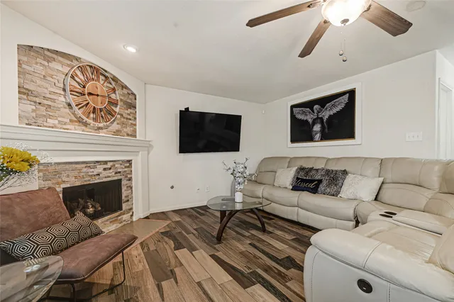 a living room with furniture a flat screen tv and a fireplace