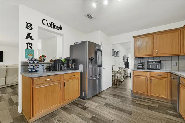 a kitchen with stainless steel appliances granite countertop a stove and cabinets